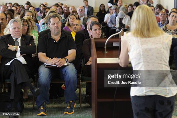 People listen as Amy Silverman speaks during a public hearing held by the Florida state Agency for Health Care Administration regarding the state's...