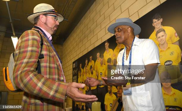 Umpire John Holder and artist Paul Trevillion at a book signing of 'You are the Umpire' during day two of the First Specsavers Test Match between...