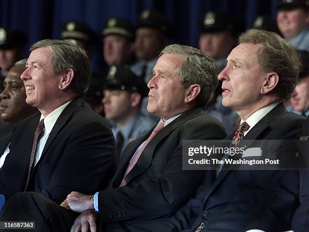 President Bush, Sen. Arlen Specter, R-PA, right, and Attorney General John Ashcroft, left, wait to speak at Philadelphia's Police Academy graduation...