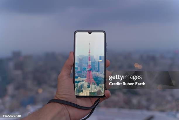 tokyo tower as seen from a smartphone - generico stock pictures, royalty-free photos & images