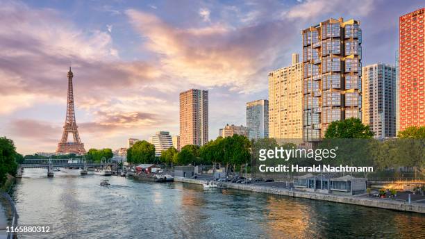 city skyline along seine river with eiffel tower and highrise buildings at front de seine, paris, france - ile de france stock pictures, royalty-free photos & images