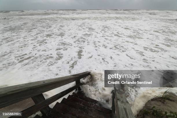 Waves brought by hurricane Dorian crash against the beach access stairs off Palmetto Avenue in Satellite Beach, on Tuesday, September 3, 2019 **...