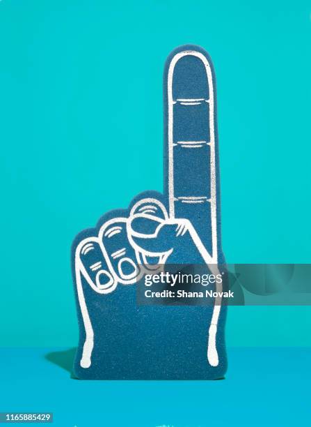 foam finger on blue - foam hand stock pictures, royalty-free photos & images