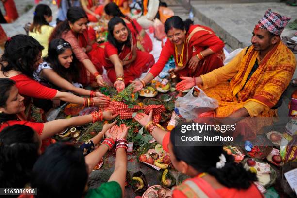 Priest offering ritual prayer at the Bank of Bagmati River of Pashupatinath Temple during Rishi Panchami Festival celebrations at Pashupatinath...