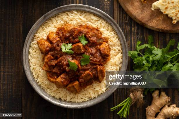 indian food chicken vindaloo curry over basmati rice - indian food spices stock pictures, royalty-free photos & images