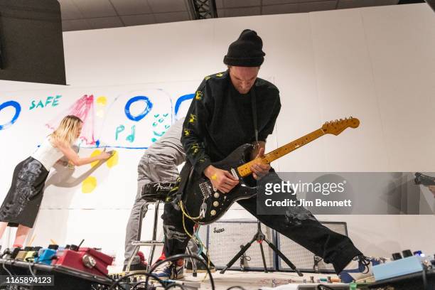 Artist Kate Neckel, guitarist and artist Mike McCready, and guitarist and artist Josh Klinghoffer of Infinite Color and Sound create live on stage...