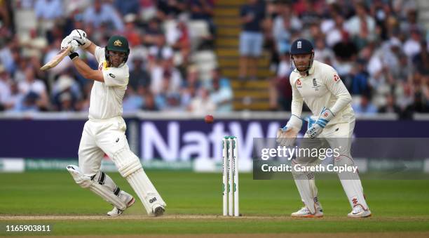 Travis Head of Australia bats watched by England wicketkeeper Jonathan Bairstow during day three of the 1st Specsavers Ashes Test between England and...