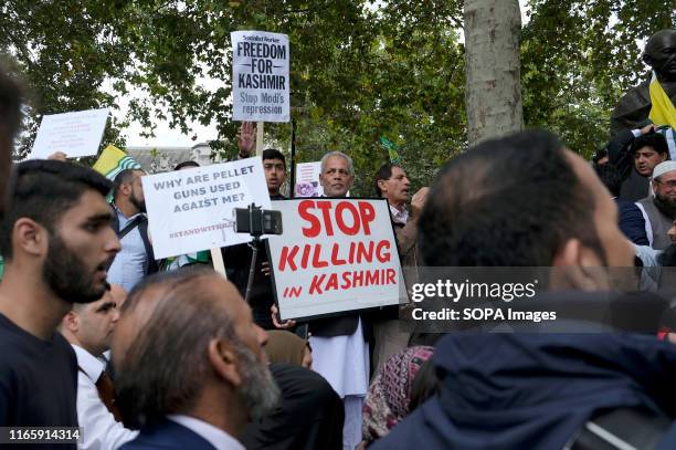 Protesters hold placard during the demonstration. Kashmir protesters gathered at Parliament Square to demand the stop of the Indian occupation in...