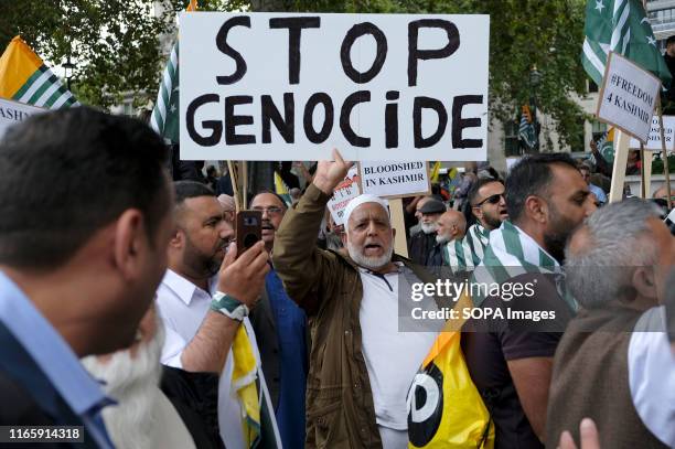 Protester holds a placard during the demonstration. Kashmir protesters gathered at Parliament Square to demand the stop of the Indian occupation in...