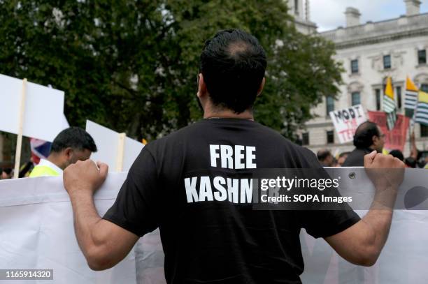 Protester dressed in a black t-shirt saying "Free Kashmir" during the demonstration. Kashmir protesters gathered at Parliament Square to demand the...