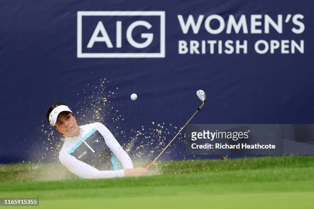 Georgia Hall of England plays from a greenside bunker on the 12th during the third round of the AIG Women's British Open at Woburn Golf Club on...