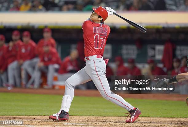 Shohei Ohtani of the Los Angeles Angels of Anaheim hits an rbi double scoring David Fletcher against the Oakland Athletics in the top of the fifth...