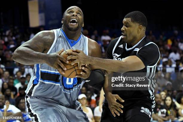 Glen Davis of the Power dribbles the ball while being guarded by Craig Smith of the Enemies in the first half during week seven of the BIG3 three on...