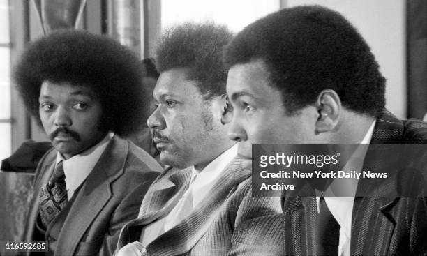 Don King, head of Don King Productions and Video Techniques, is flanked by Rev. Jesse Jackson and Muhammad Ali during news conference at United...