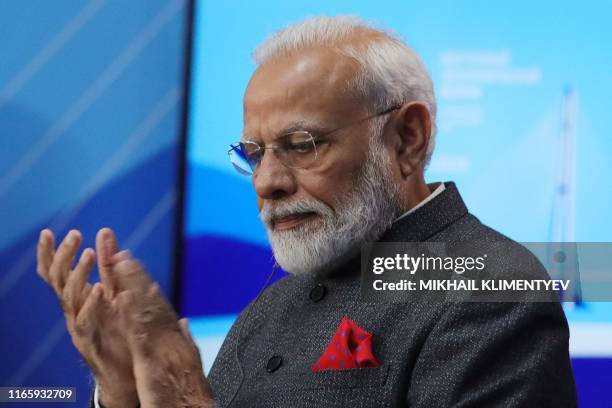 Prime Minister Narendra Modi applauds to Russian President during their talks as part of the Eastern Economic Forum in Vladivostok on September 4,...