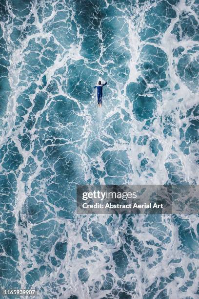 surfer waiting for the big next wave shot by drone, lanzarote - außergewöhnliche sportarten stock-fotos und bilder