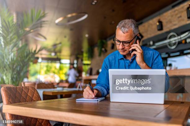 hij weet hoe hij dingen gedaan moet krijgen - internet cafe stockfoto's en -beelden