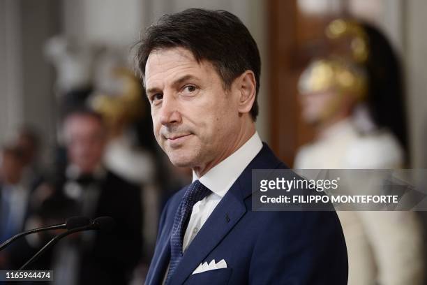 Italy's premier-designate Giuseppe Conte reacts as he starts to read the list of his new cabinet after a meeting with Italian President, at the...