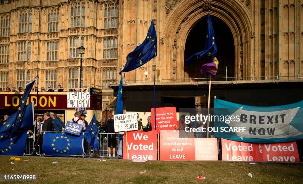 Pro-Brexit and anti-Brexit protest banners and EU flags are seen outside the Houses of Parliament in central London on September 4, 2019. - British...