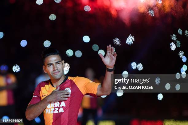 Galatasaray FC's Colombian striker Radamel Falcao waves to fans during a signing cerenomy for his new transfer at the TT Arena stadium in Istanbul on...