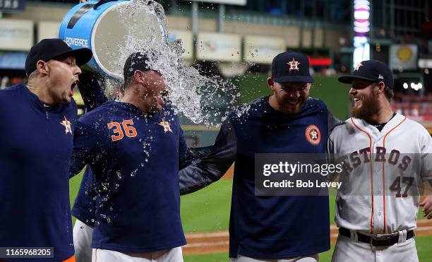 Aaron Sanchez of the Houston Astros, Will Harris, Joe Biagini and Chris Devenski are doused with water by Collin McHugh after combining for a no...