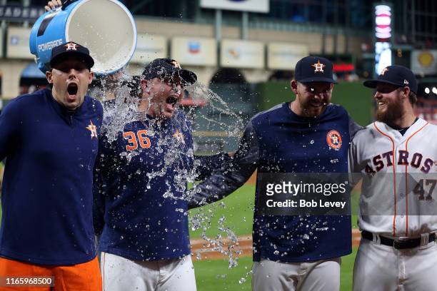 Aaron Sanchez of the Houston Astros, Will Harris, Joe Biagini and Chris Devenski are doused with water by Collin McHugh after combining for a no...