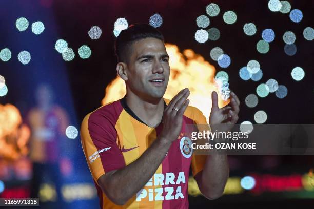 Galatasaray FC presents Colombian striker Radamel Falcao salutes fans during a signing cerenomy for their new transfers at TT Arena stadium in...