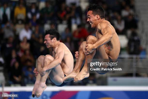 Yahel Castillo and Juan Manuel Celaya of Mexico compete in Men's Synchronised Diving 3m Springboard Final at Aquatics Center of Villa Deportiva...