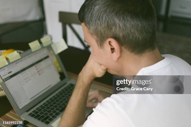 man stares at laptop screen - staring at screen stock pictures, royalty-free photos & images
