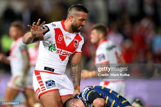 Paul Vaughan of the Dragons makes a one armed tackle with a broken finger during the round 20 NRL match between the St George Illawarra Dragons and...