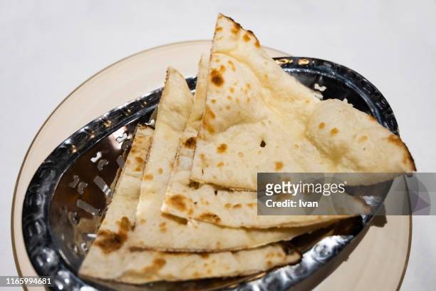 traditional indian cuisine, food, indian naan bread on rustic metal tray - naan stock pictures, royalty-free photos & images