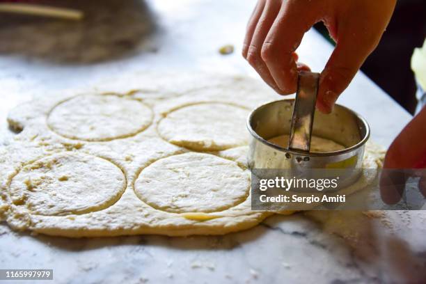 cutting dough circles with cookie cutter - cookie cutter stock pictures, royalty-free photos & images
