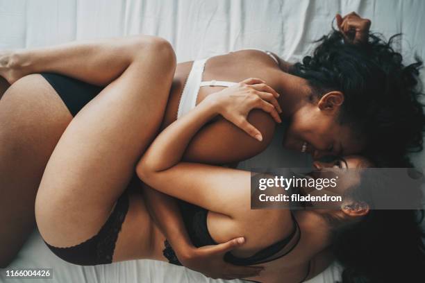 lesbian couple - lesbian bed stock pictures, royalty-free photos & images