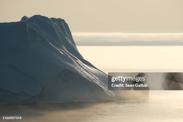 Massive iceberg stands at the mouth of the Ilulissat Icefjord during a week of unseasonably warm weather on August 3, 2019 near Ilulissat, Greenland....