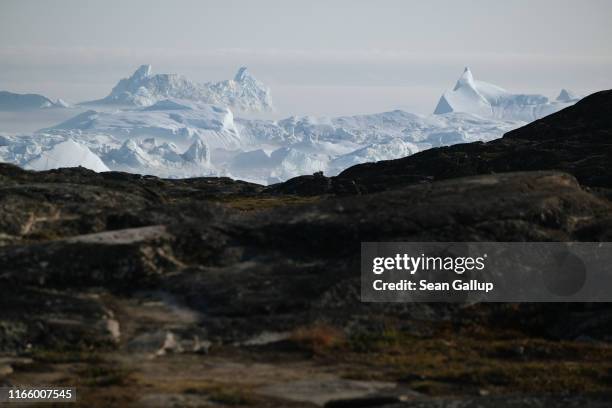 Icebergs loom from the Ilulissat Icefjord during a week of unseasonably warm weather on August 3, 2019 near Ilulissat, Greenland. The Sahara heat...