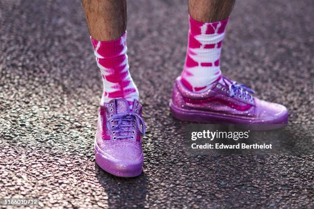 Guest wears tie-and-dye hot-pink and white socks, glittering mauve lame sneakers, outside Miu Miu Club 2020, on June 29, 2019 in Paris, France.