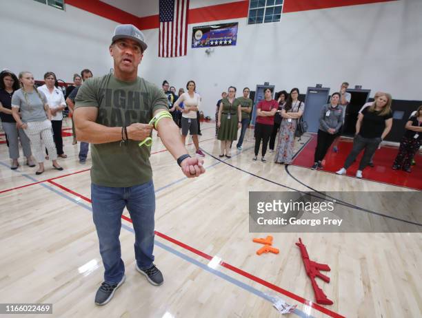 Dave Acosta, founder of Fight Back demonstrates how to use a tourniquet to stop bleeding during an active shooter event for teachers from Freedom...