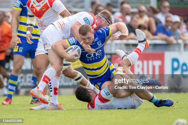 August 3: Jack Hughes of Warrington Wolves tackled by Benjamin Garcia of Catalans Dragons and Remi Casty of Catalans Dragons during the Catalans...