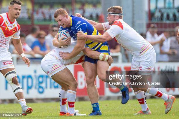 August 3: Jack Hughes of Warrington Wolves tackled by Benjamin Garcia of Catalans Dragons and Remi Casty of Catalans Dragons during the Catalans...