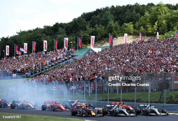 Max Verstappen of the Netherlands driving the Aston Martin Red Bull Racing RB15, Valtteri Bottas driving the Mercedes AMG Petronas F1 Team Mercedes...