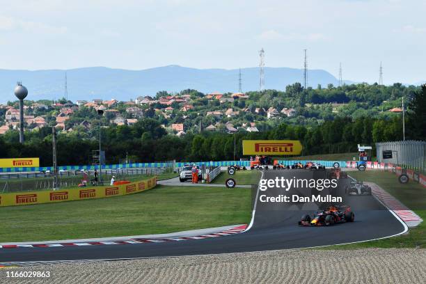 Max Verstappen of the Netherlands driving the Aston Martin Red Bull Racing RB15 leads Lewis Hamilton of Great Britain driving the Mercedes AMG...