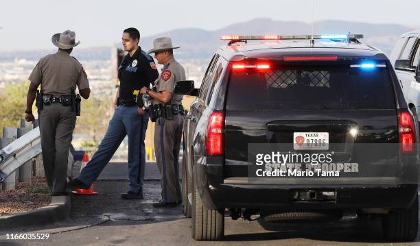 Police keep watch outside a Walmart near the scene of a mass shooting which left at least 20 people dead on August 4, 2019 in El Paso, Texas. A...