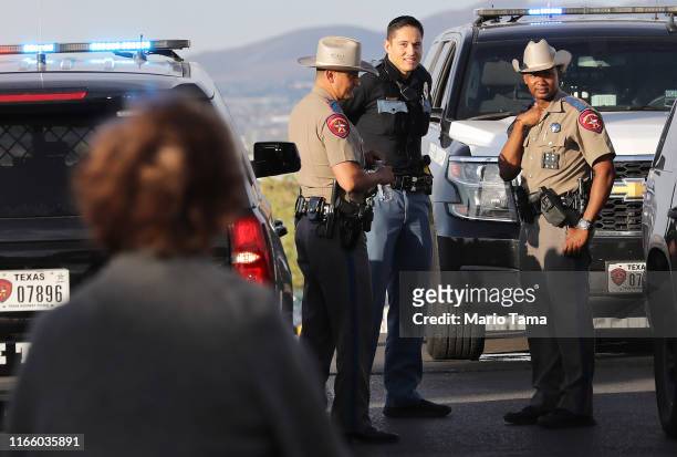 Police keep watch outside a Walmart near the scene of a mass shooting which left at least 20 people dead on August 4, 2019 in El Paso, Texas. A...