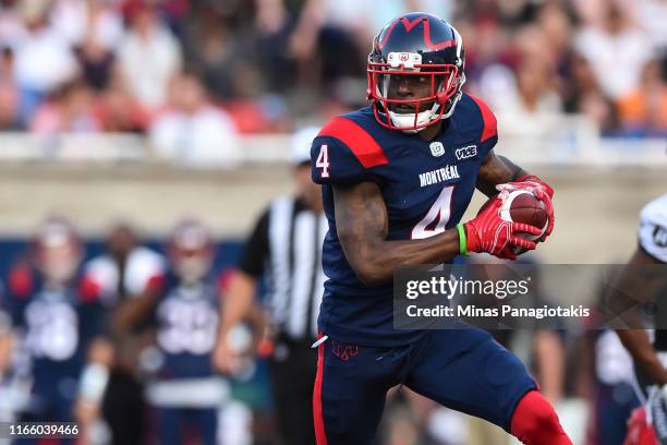 Wide receiver Quan Bray of the Montreal Alouettes runs the ball against the Ottawa RedBlacks during the CFL game at Percival Molson Stadium on August...