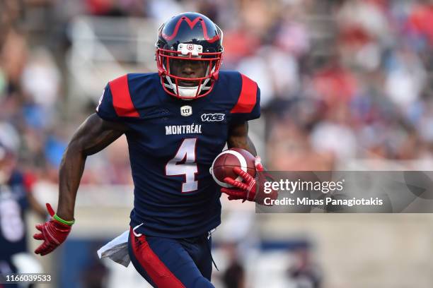 Wide receiver Quan Bray of the Montreal Alouettes runs the ball against the Ottawa RedBlacks during the CFL game at Percival Molson Stadium on August...