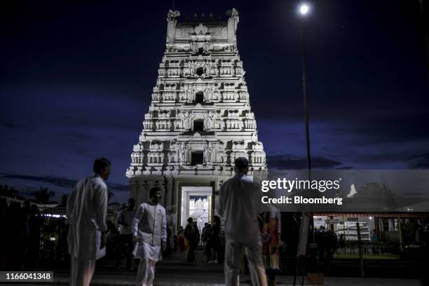 Visitors gather outside the Balaji Temple in Guwahati, Assam, India, on Saturday, Aug. 31, 2019. A sense of betrayal and anger is growing in Muslim...