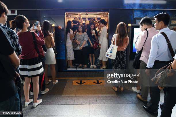 Passengers stand at a carriage door while travelling aboard a BTS skytrain in Bangkok, Thailand. 05 September 2019.