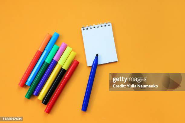 felt-tip pens and blank notepad on yellow background. concept of the educational process, study at school. back to school concept. - blue felt stock pictures, royalty-free photos & images