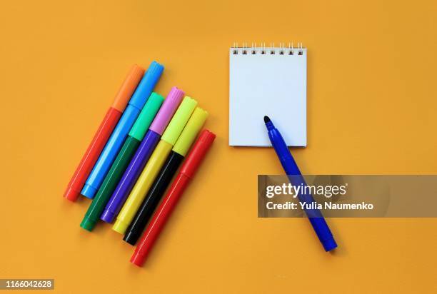 felt-tip pens and blank notepad on yellow background. concept of the educational process, study at school. back to school concept. - distance marker fotografías e imágenes de stock