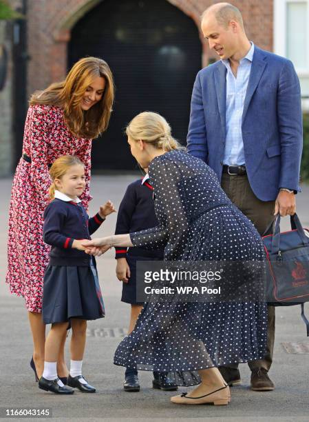 Helen Haslem, head of the lower school greets Princess Charlotte as she arrives for her first day of school, with her brother Prince George and her...